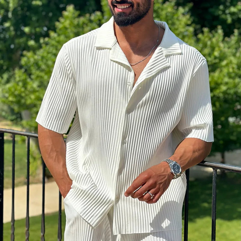 Close-up of white pleated shirt with camp collar and matching two piece set