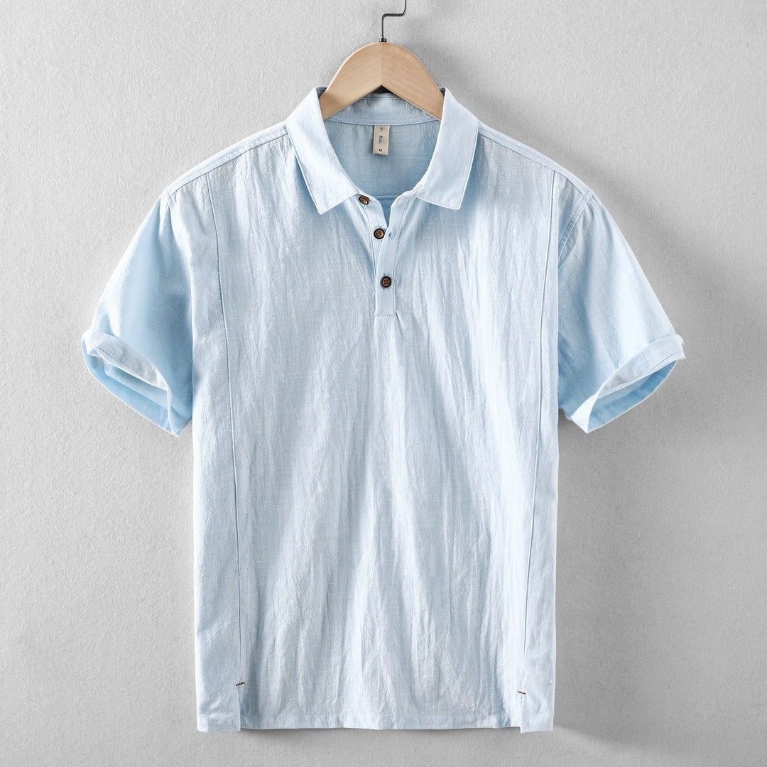 Light blue men's casual short sleeve linen shirt with button placket and rolled sleeves