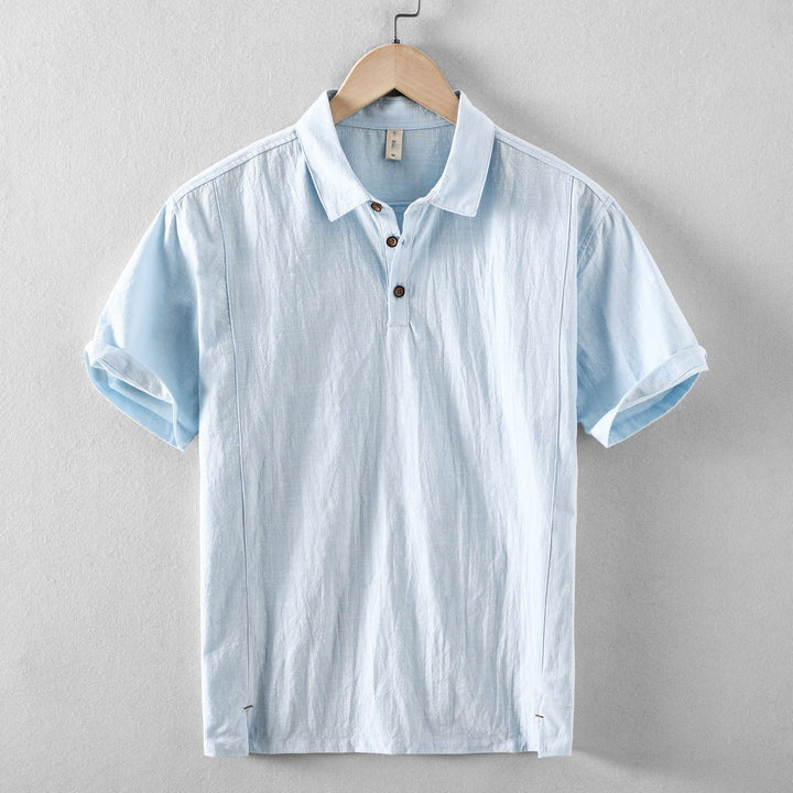 Light blue men's casual short sleeve linen shirt with button placket and rolled sleeves