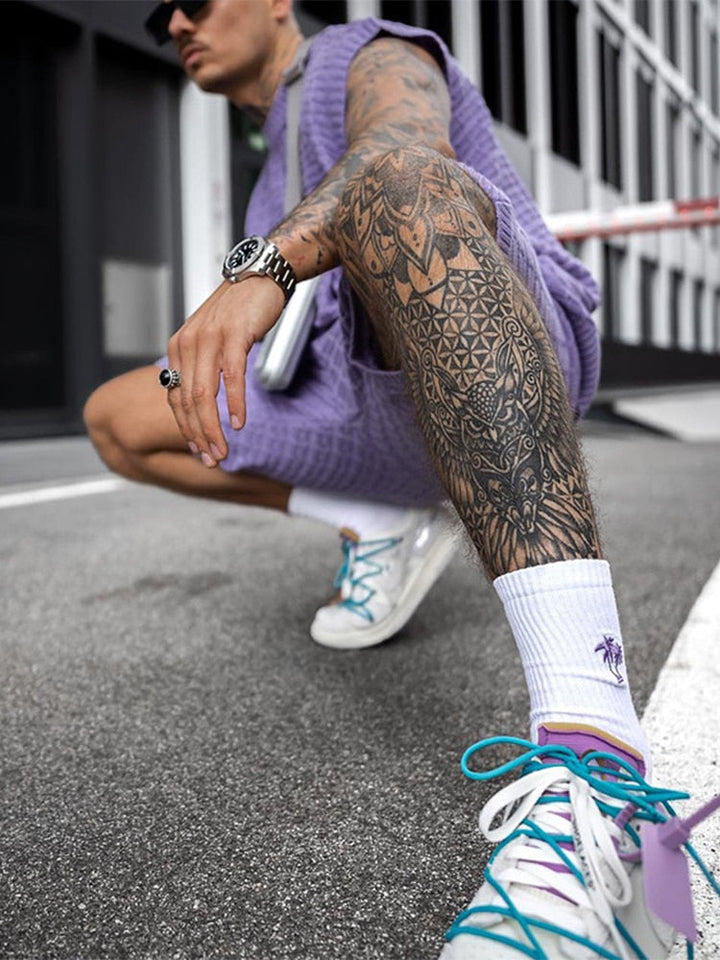 Side view of purple sleeveless knit shorts set with matching shorts and white sneakers