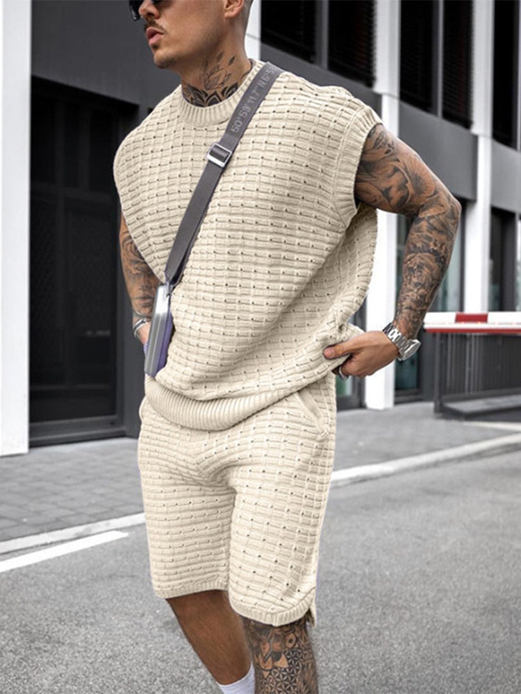 Side view of beige sleeveless knit shorts set with textured shirt and matching shorts