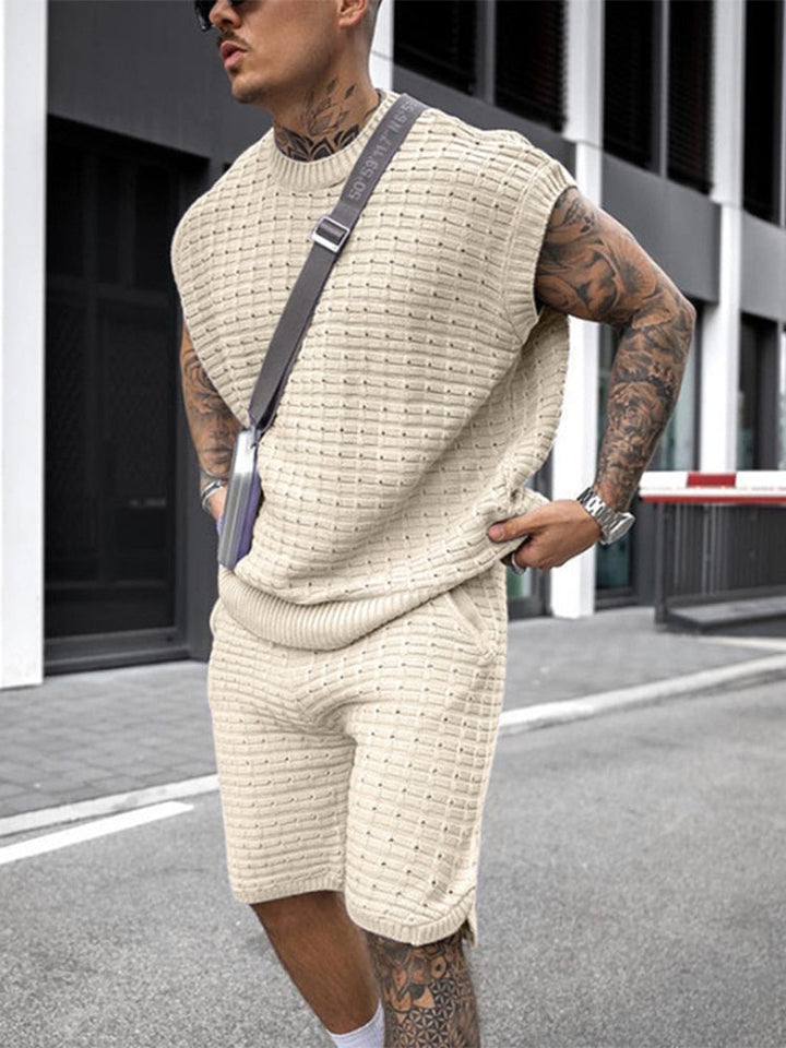 Side view of beige sleeveless knit shorts set with textured shirt and matching shorts