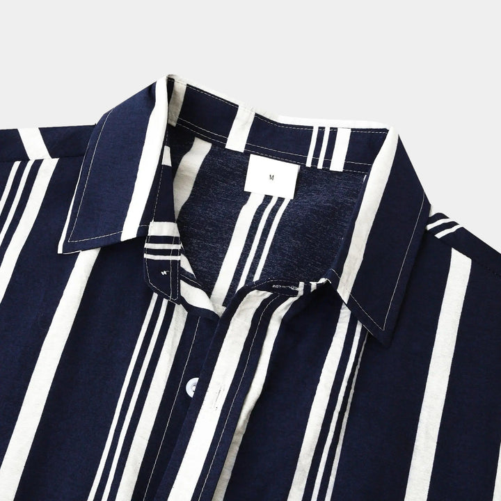 Close-up of shirt collar and chest area on navy striped casual button up shirt