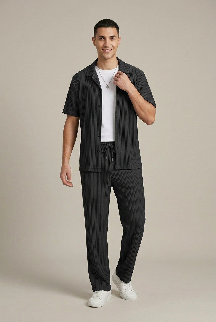 Full-length black textured stripe shirt and pants set with short sleeves, drawstring waist, and white sneakers