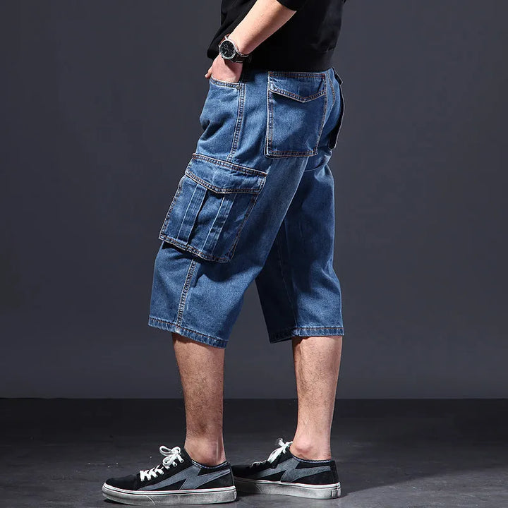 Side view of men's denim cargo shorts showing oversized leg pocket and relaxed fit