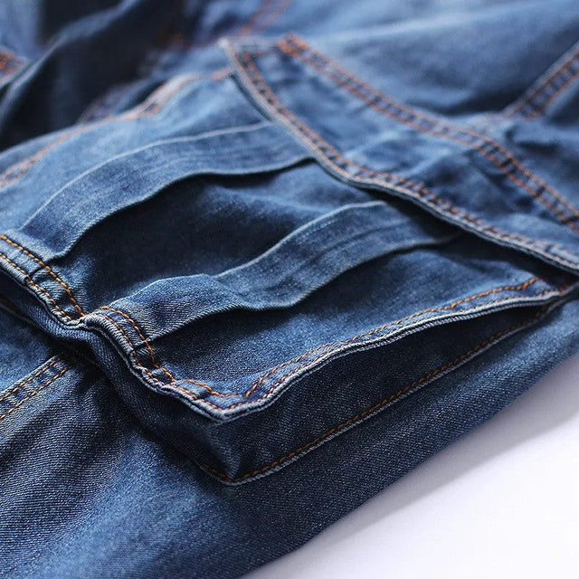 Close-up of stacked cargo shorts pockets and stitching on men's denim knee length shorts