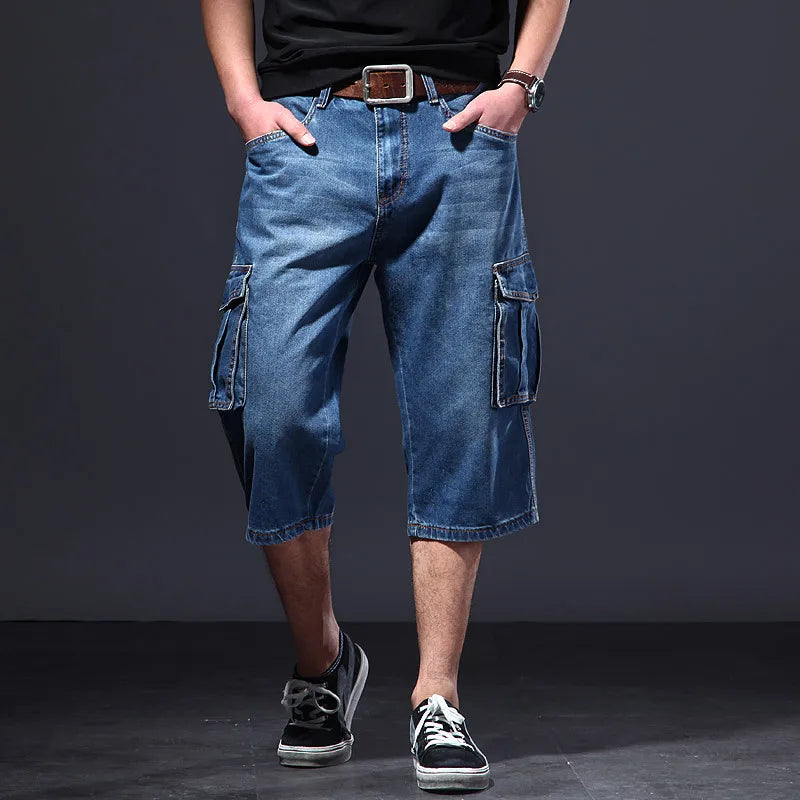 Front view of men's denim cargo knee length shorts with side flap pockets and faded blue wash