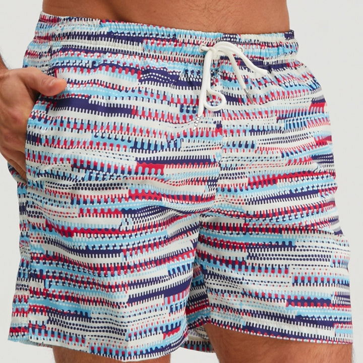 Close-up front view of men's graphic swim shorts showing waistband, drawstring, and bright striped print