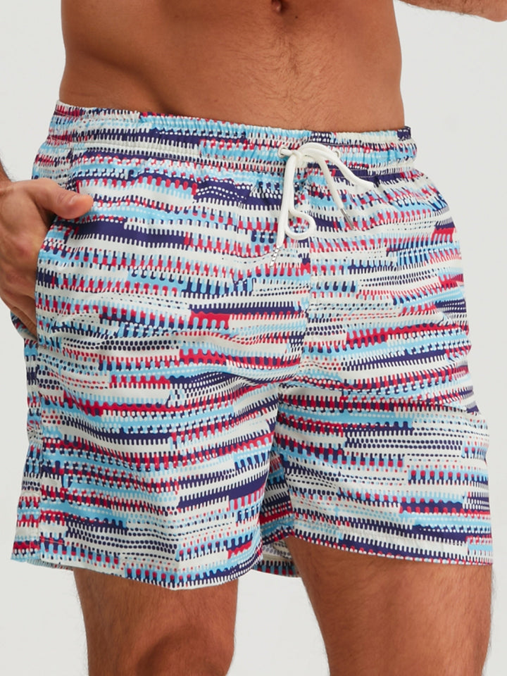 Front view of men's graphic swim shorts with blue, red, and navy stripe print and white drawstring