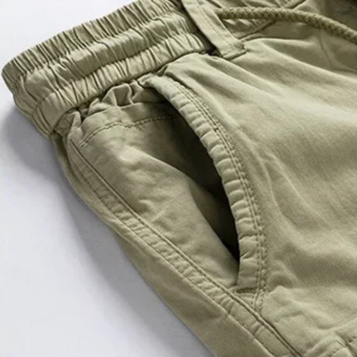 Side view of khaki cargo shorts showing elastic waistband and roomy thigh pocket