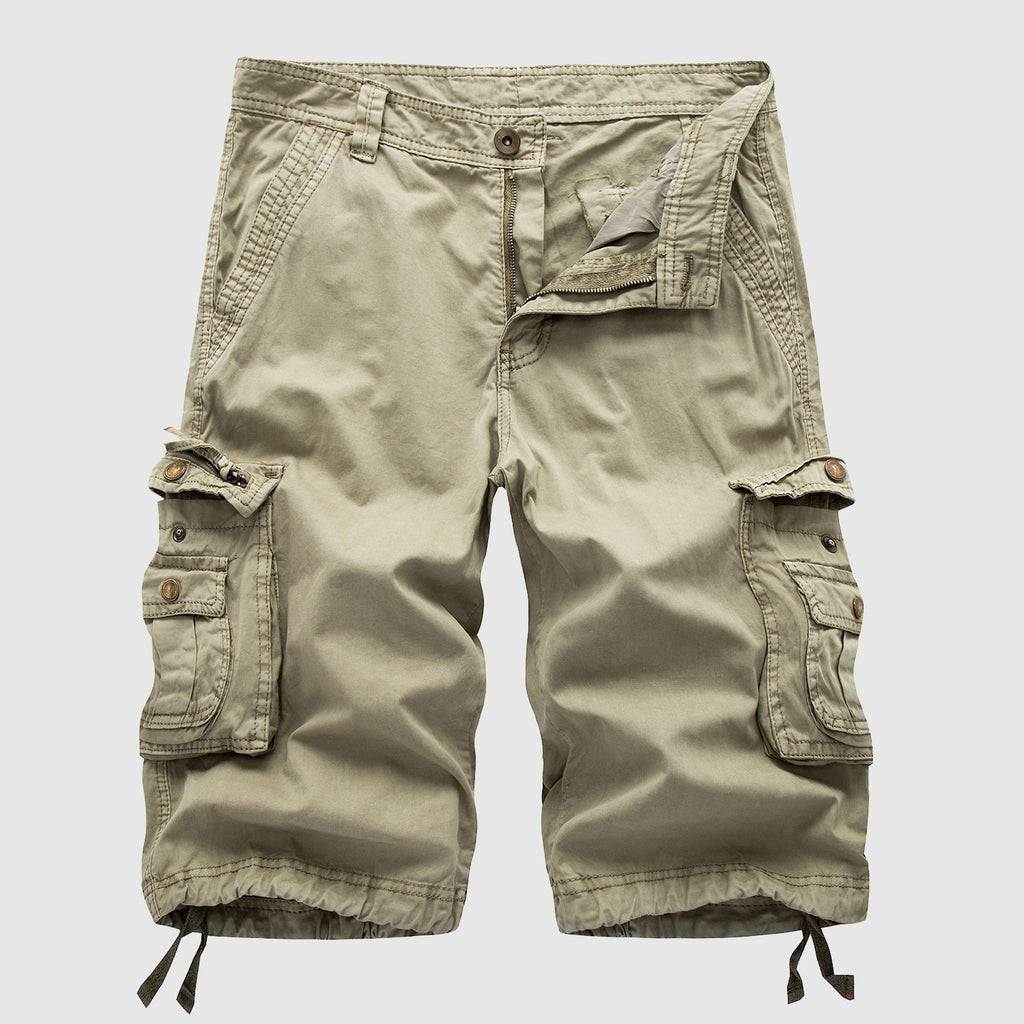 Khaki knee length cargo shorts with side flap pockets, drawstring hems, and front zipper detail