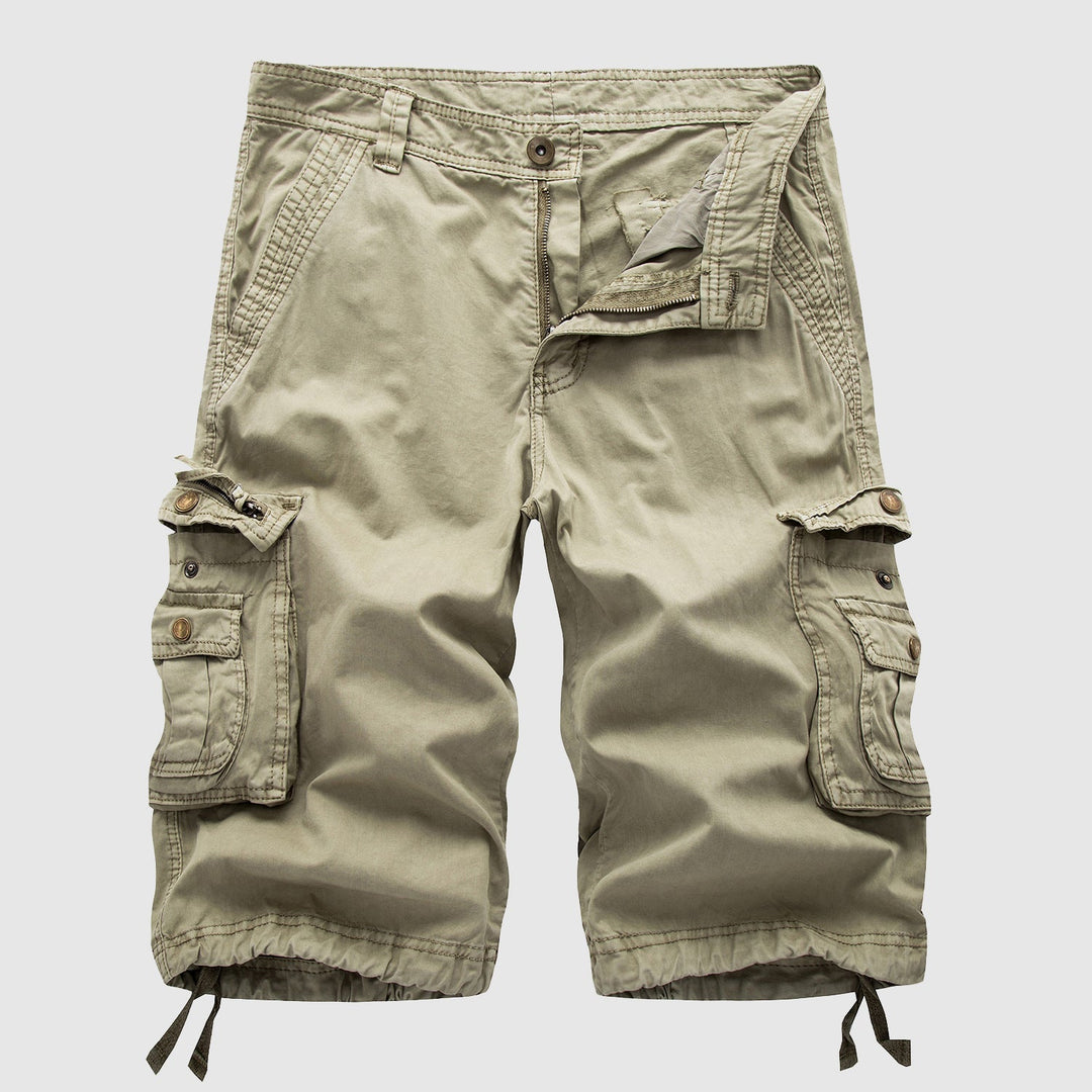Khaki knee length cargo shorts with side flap pockets, drawstring hems, and front zipper detail
