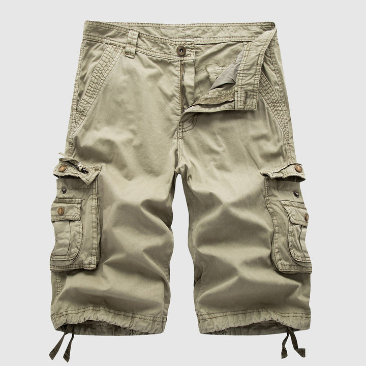 Khaki knee length cargo shorts with side flap pockets, drawstring hems, and front zipper detail