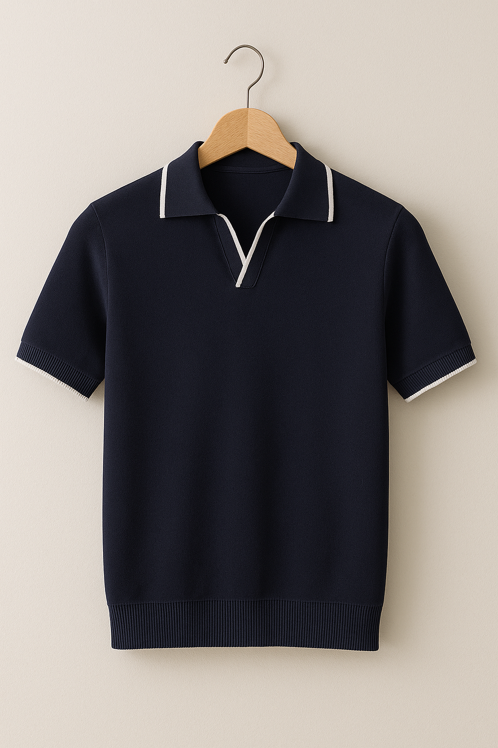 Hanging navy knit polo shirt with white contrast trim and short sleeves