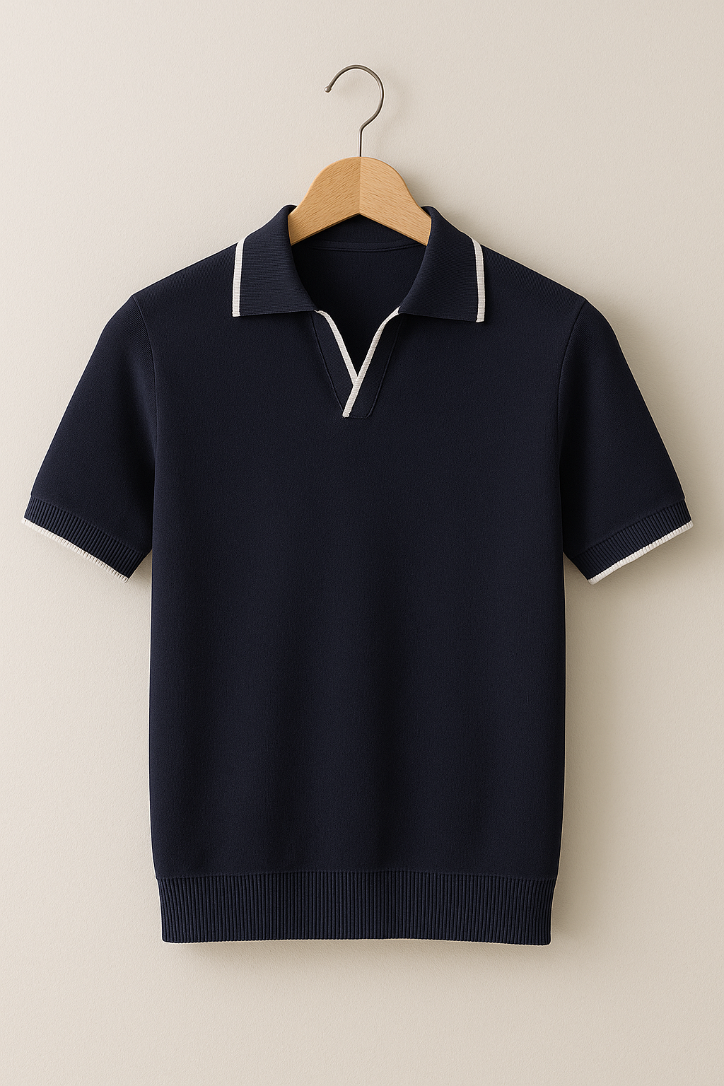 Hanging navy knit polo shirt with white contrast trim and short sleeves
