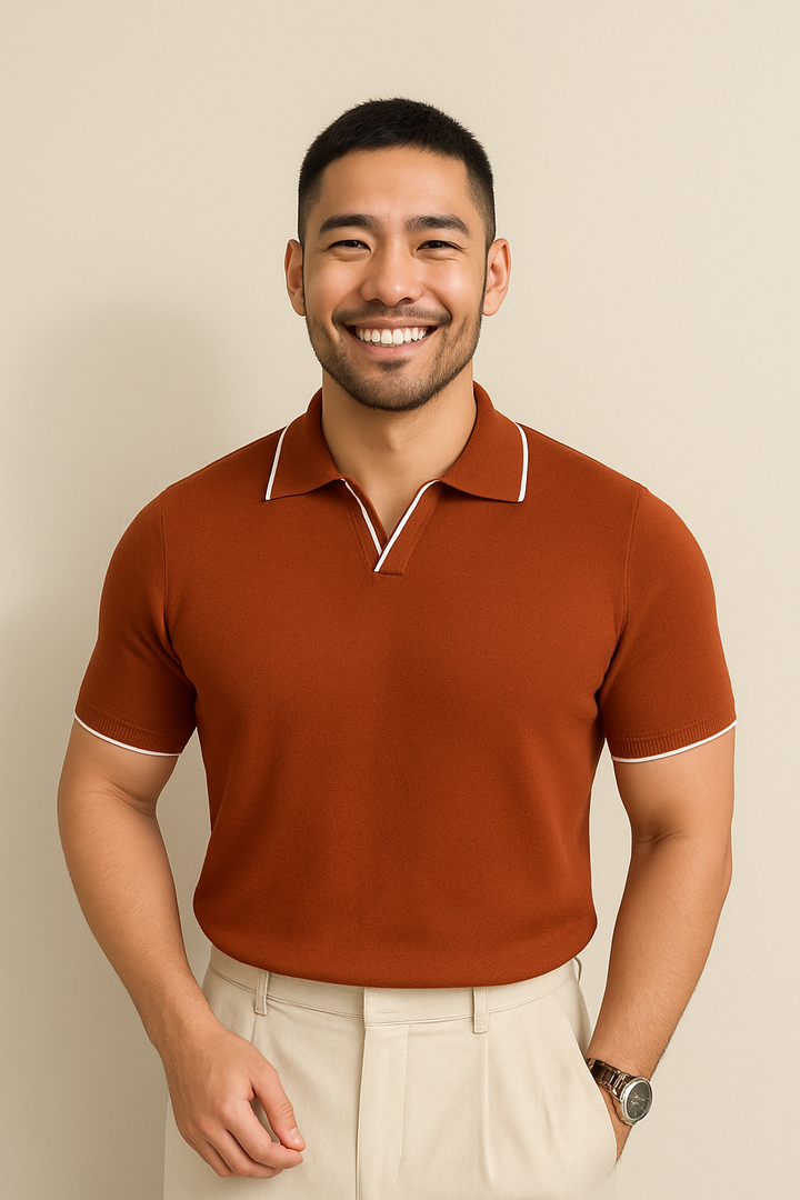Rust brown knit polo shirt with white contrast trim worn with light trousers