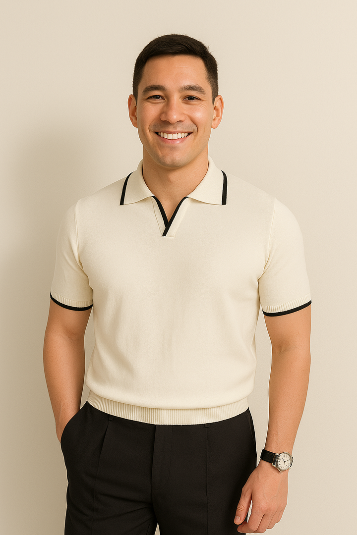 Cream knit polo shirt with black contrast trim worn with black pants