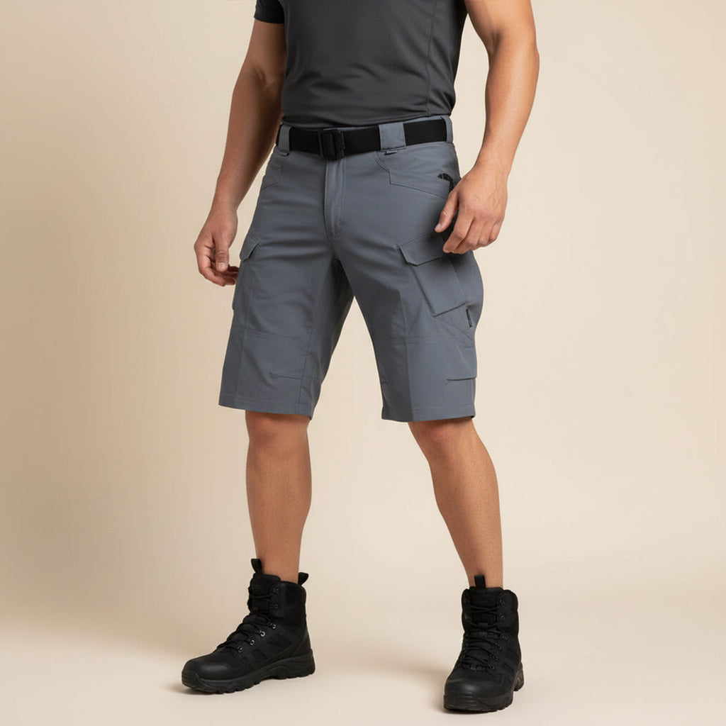 Front view of gray tactical cargo shorts worn with black shirt and boots