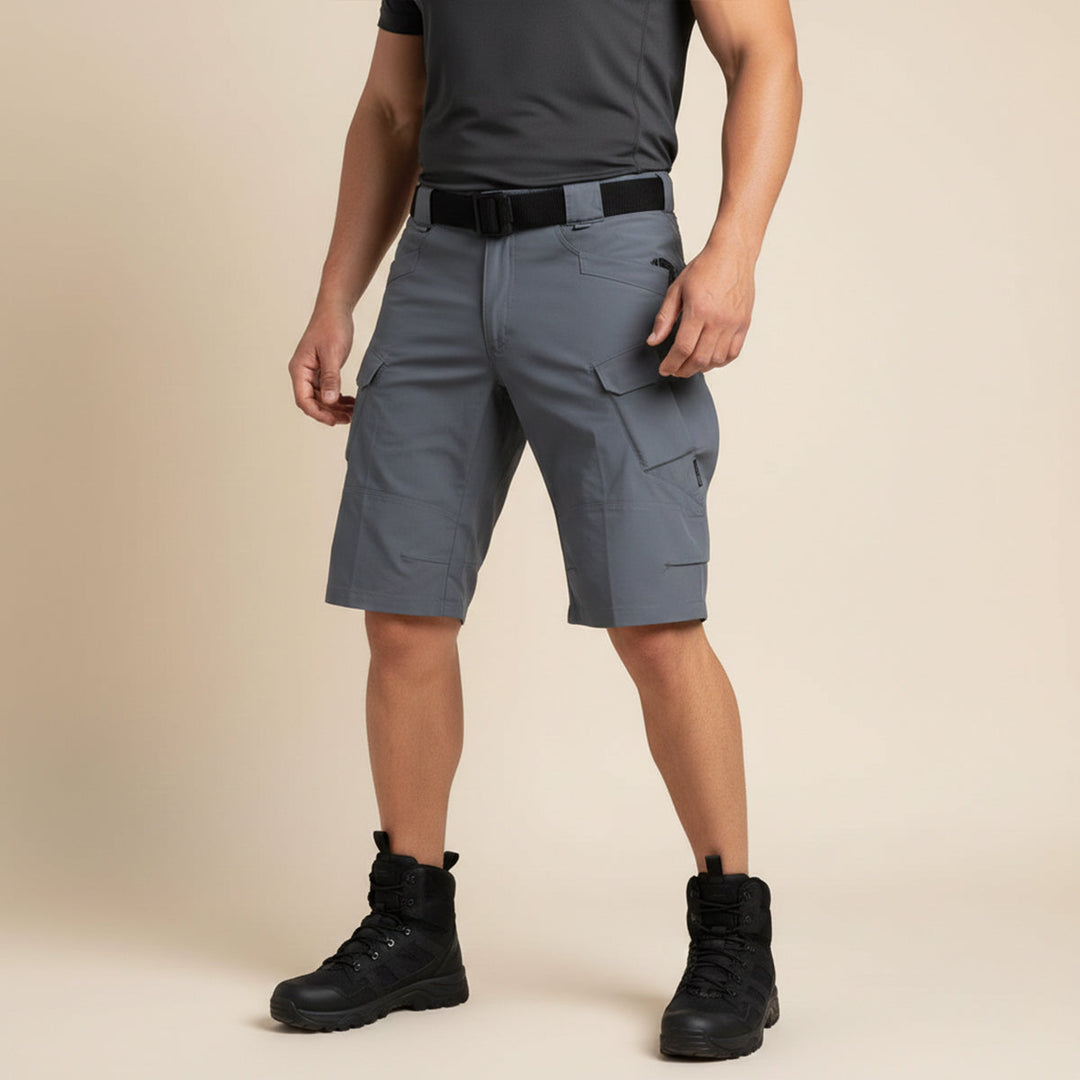 Front view of gray tactical cargo shorts worn with black shirt and boots
