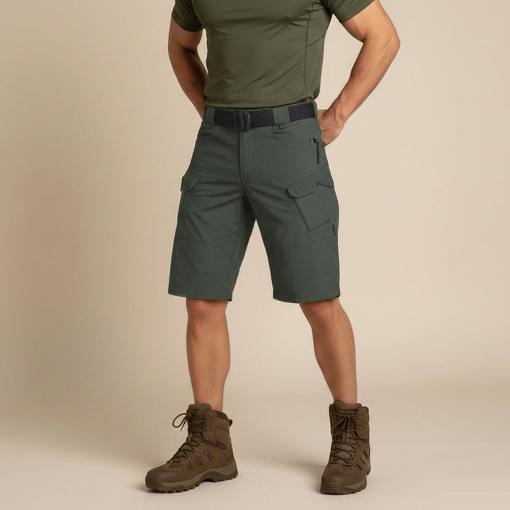 Front view of olive tactical cargo shorts worn with boots and fitted shirt
