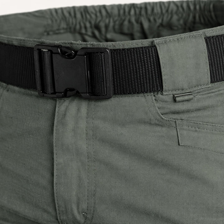 Close-up of olive tactical shorts waistband with black belt and elastic back