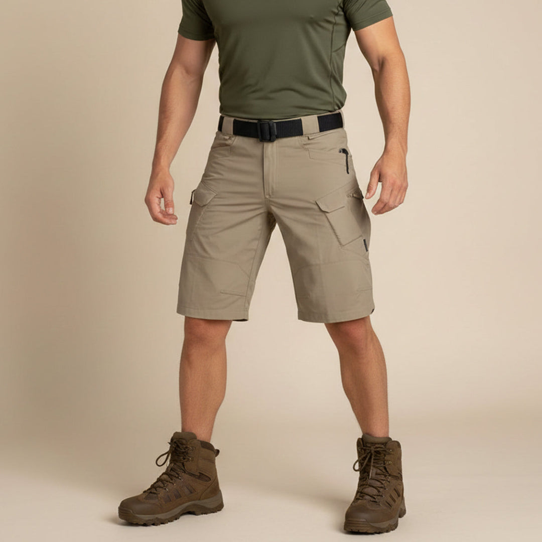 Front view of khaki tactical cargo shorts worn with olive shirt and boots
