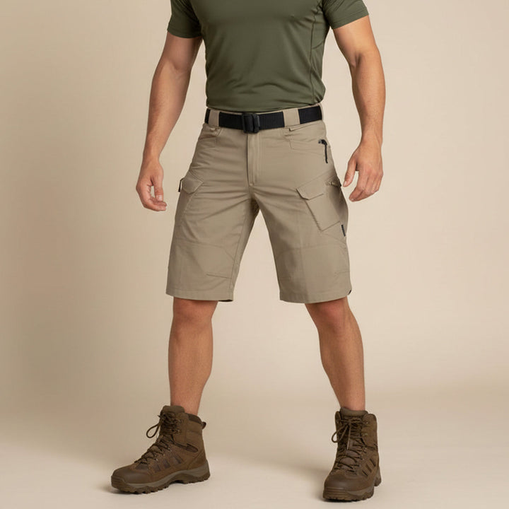 Front view of khaki tactical cargo shorts worn with olive shirt and boots