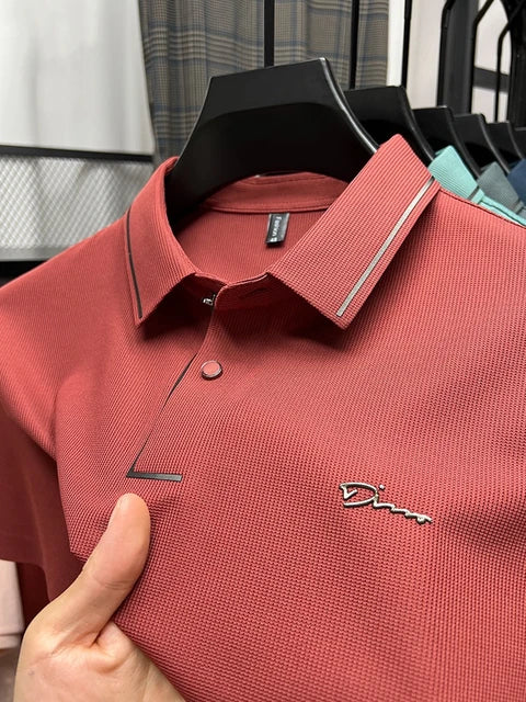 Red pique knit short sleeve polo shirt on hanger with textured fabric and logo