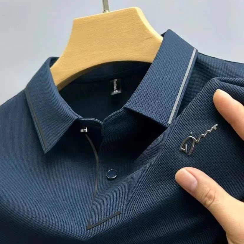 Navy blue pique knit polo shirt with striped collar detail and short sleeves