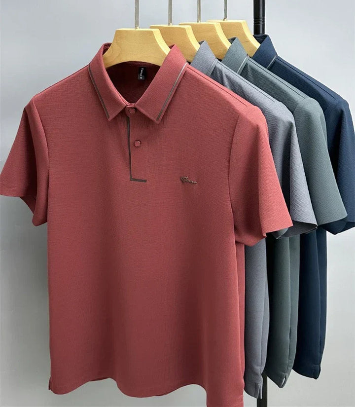 Men's pique knit polo shirts in rust red, blue, gray, teal, and navy on hangers