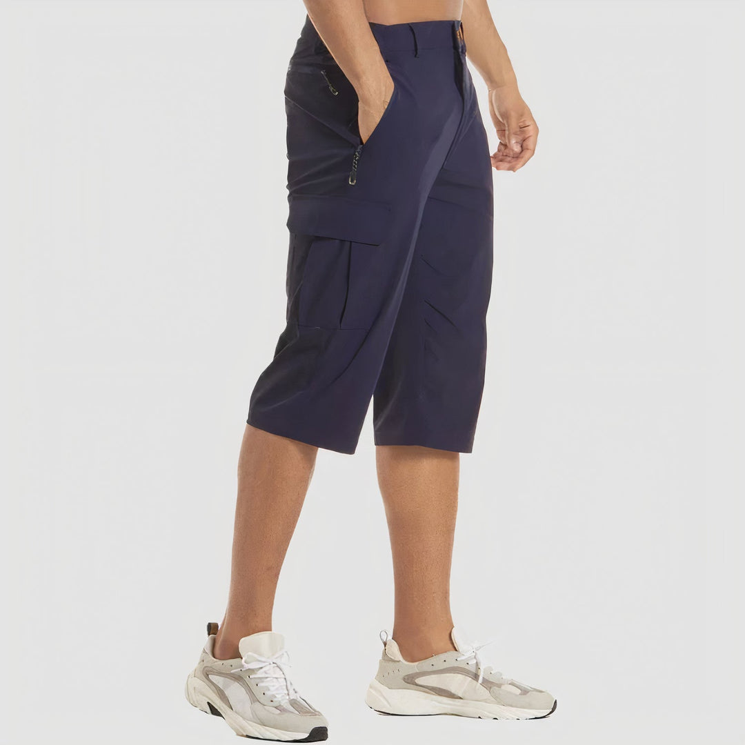 Side view navy quick dry cargo shorts showing zippered pocket and layered cargo pocket flap