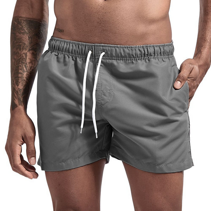 Gray men's swim shorts with quick dry fabric, white drawstring waist and side pockets, front view