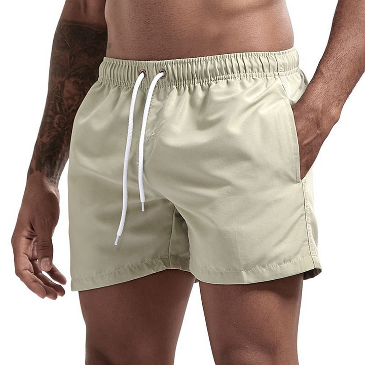 Light khaki men's swimsuit shorts with elastic drawstring waist and side pockets, quick dry fabric front