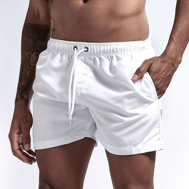 White men's swim shorts with quick dry fabric, drawstring waistband and pocket detail, front view