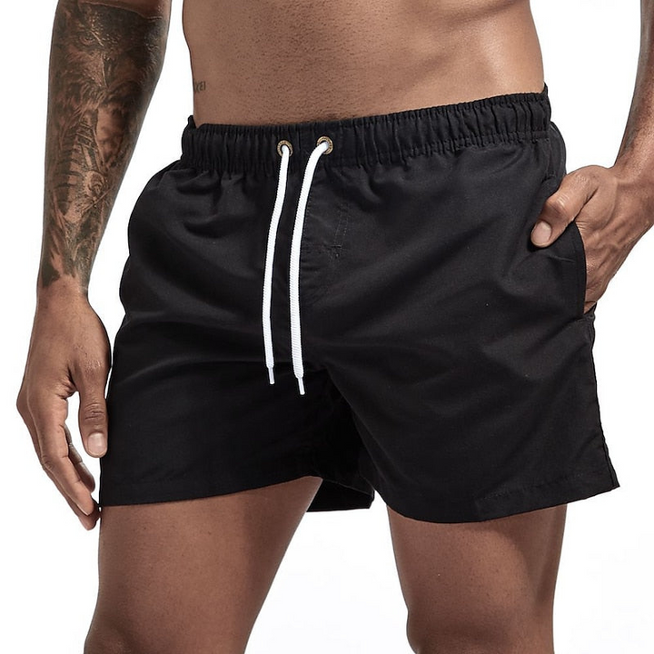 Black men's quick dry swim shorts with white drawstring, elastic waist and side pocket, front view