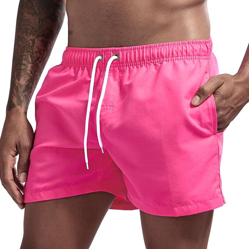 pink men's quick dry swim shorts with drawstring elastic waist and pocket, front angled view