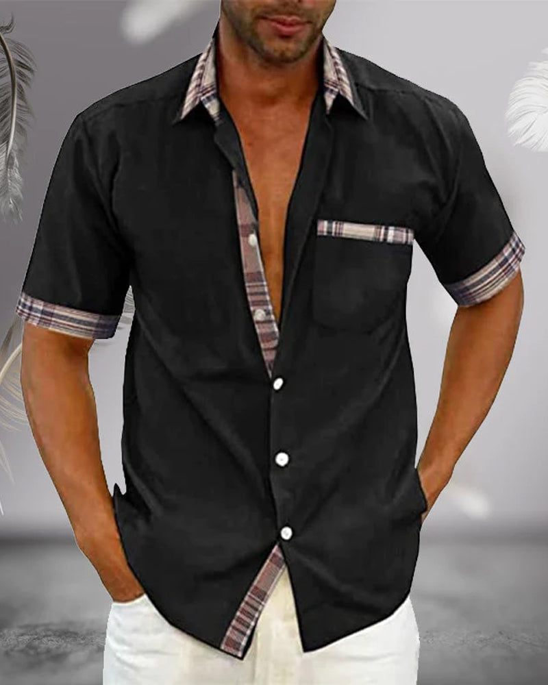 Black short sleeve button up shirt with collar, plaid accents, chest pocket, and casual style