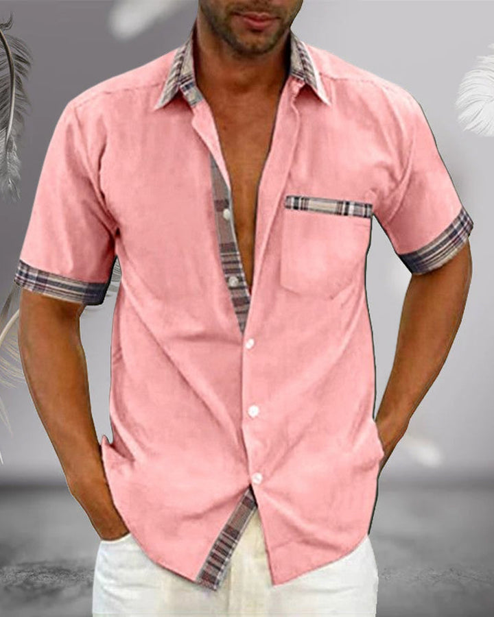 Pink short sleeve button up shirt with collar, plaid trim, chest pocket, and relaxed button front