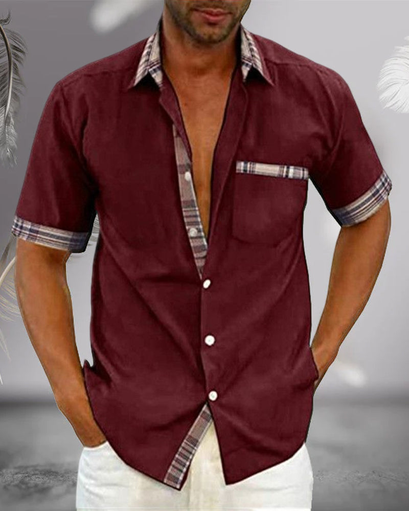 Burgundy short sleeve button up shirt with collar, plaid trim, chest pocket, and casual fit