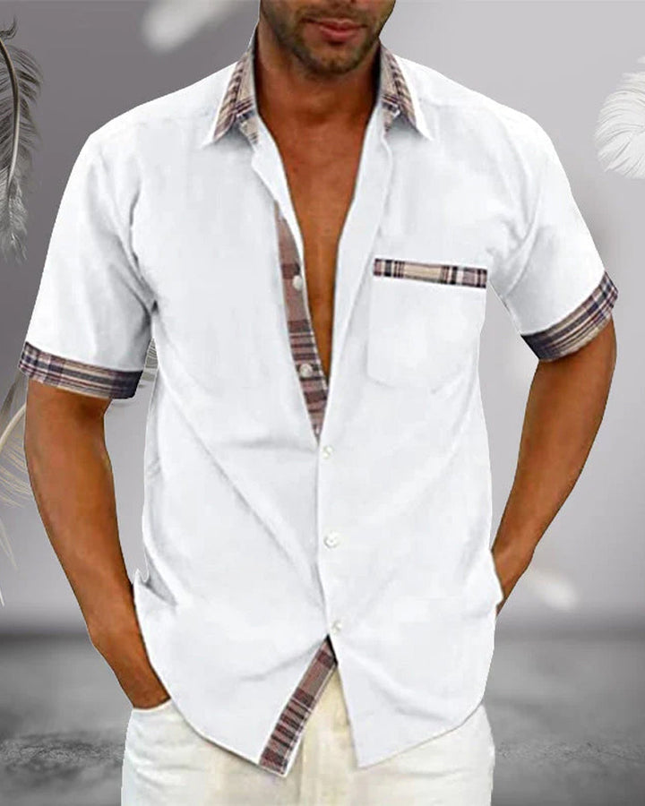 White short sleeve button up shirt with collar, plaid trim, chest pocket, and casual fit