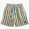 Men's beige swim shorts with dark green vertical stripes, drawstring waist, and logo patch