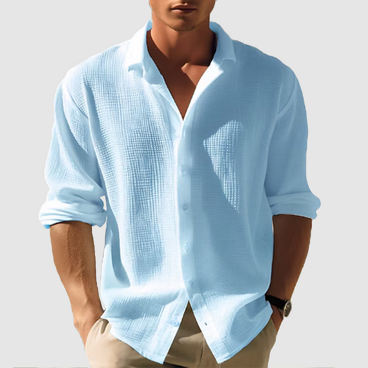 Light blue men's summer button down shirt with long sleeves and textured fabric