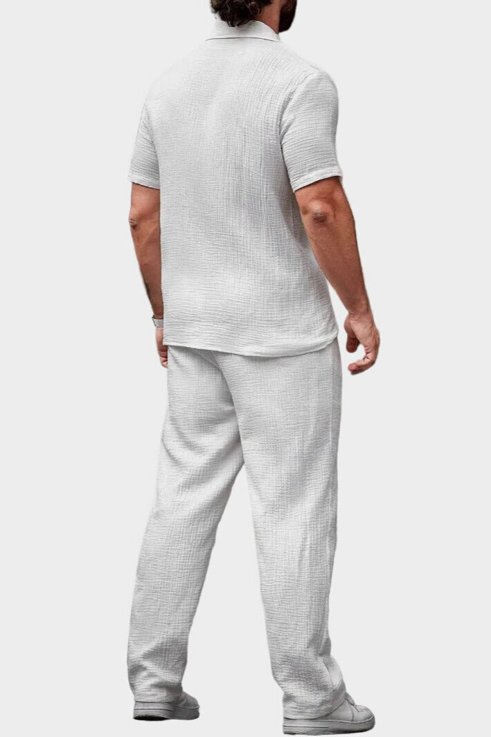 Back view of men's white summer shirt and pants set in lightweight textured fabric
