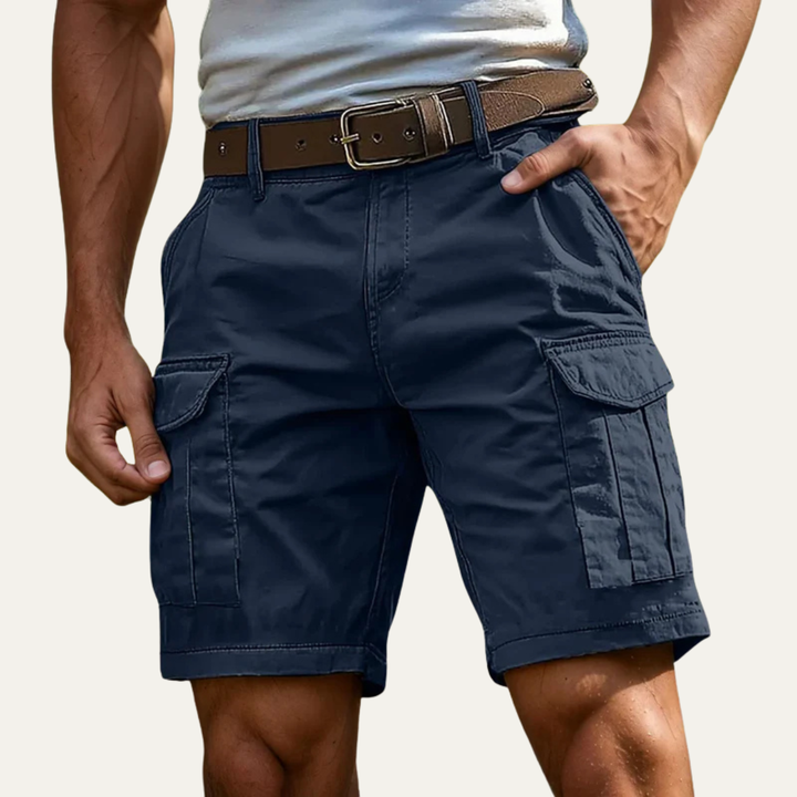 Navy blue cargo shorts for men with side flap pockets and knee-length cut