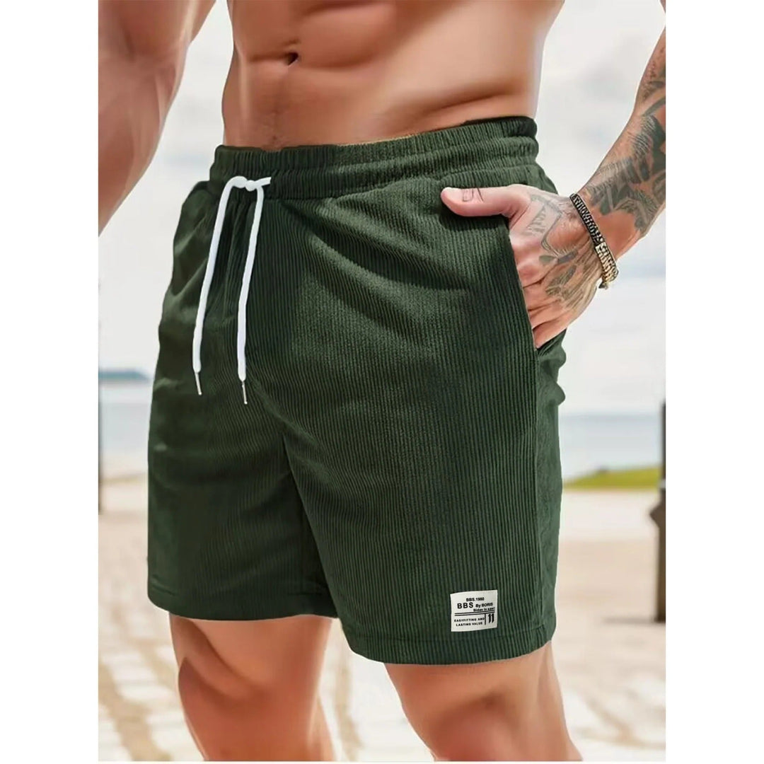 Dark green ribbed men's summer casual shorts with pockets, drawstring waist and logo patch