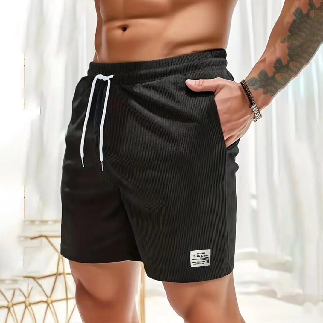 Black ribbed men's summer casual shorts with pockets, white drawstring and side hand pocket