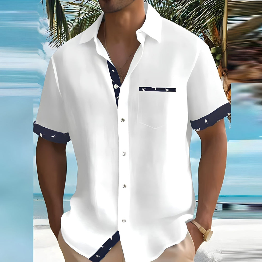 White men's summer casual shirt with navy patterned cuffs, collar lining, and pocket trim