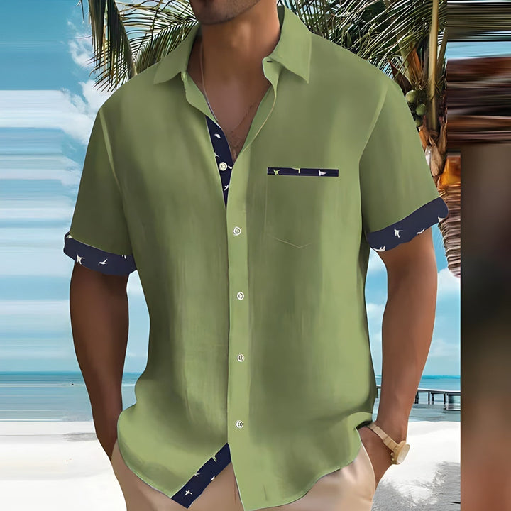 Olive green men's summer shirt with short sleeves, button front, and navy patterned cuff accents
