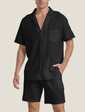 Black short sleeve shirt and shorts set with open collar and chest pocket, casual summer outfit