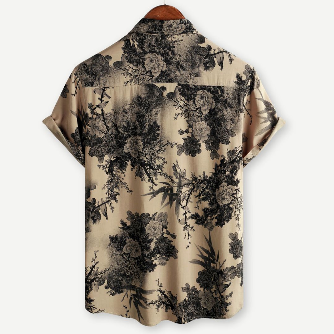 Back view of beige men's floral shirt with black allover botanical pattern and short sleeves